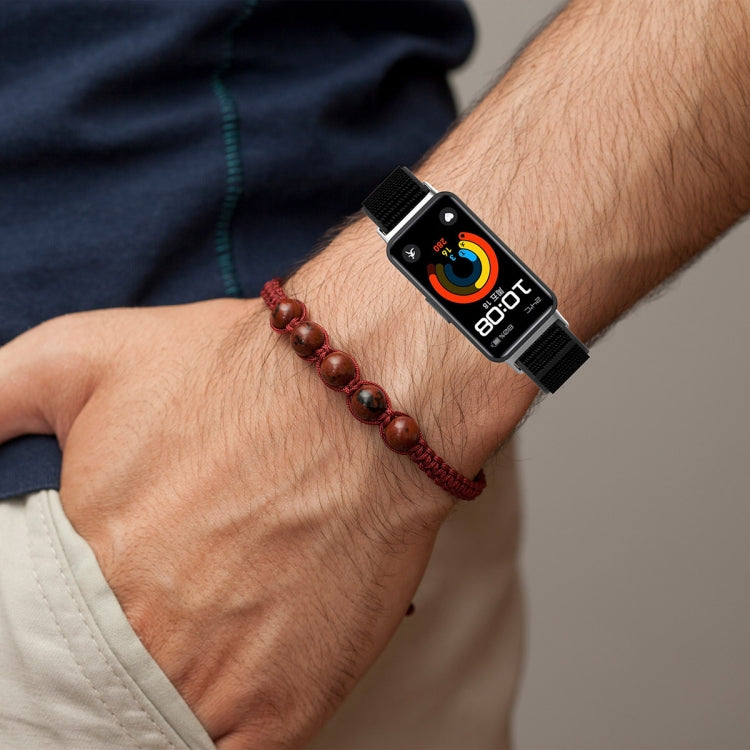 Black nylon watch band worn on a wrist with a fitness tracker