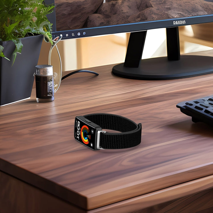 Black nylon hook-and-loop watch band fitted to a fitness tracker