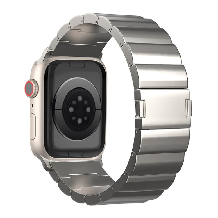 Silver titanium watch band with broad links and a magnetic clasp, shown on a watch from the back.