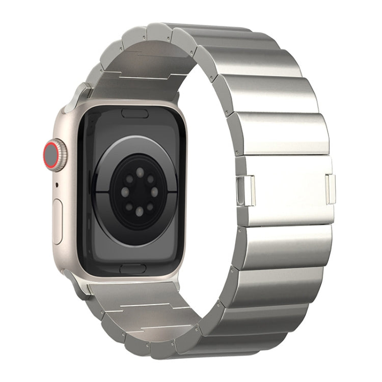 Silver smartwatch band with broad titanium links and magnetic closure