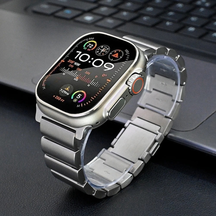 Silver titanium metal watch band with broad links fitted to a smartwatch