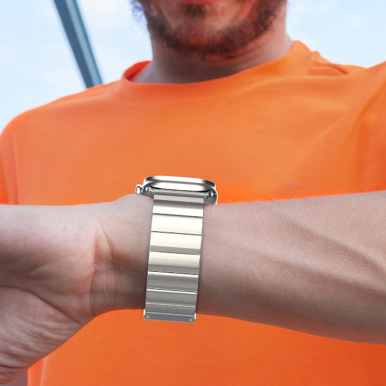 Silver titanium metal watch band with broad links worn on the wrist