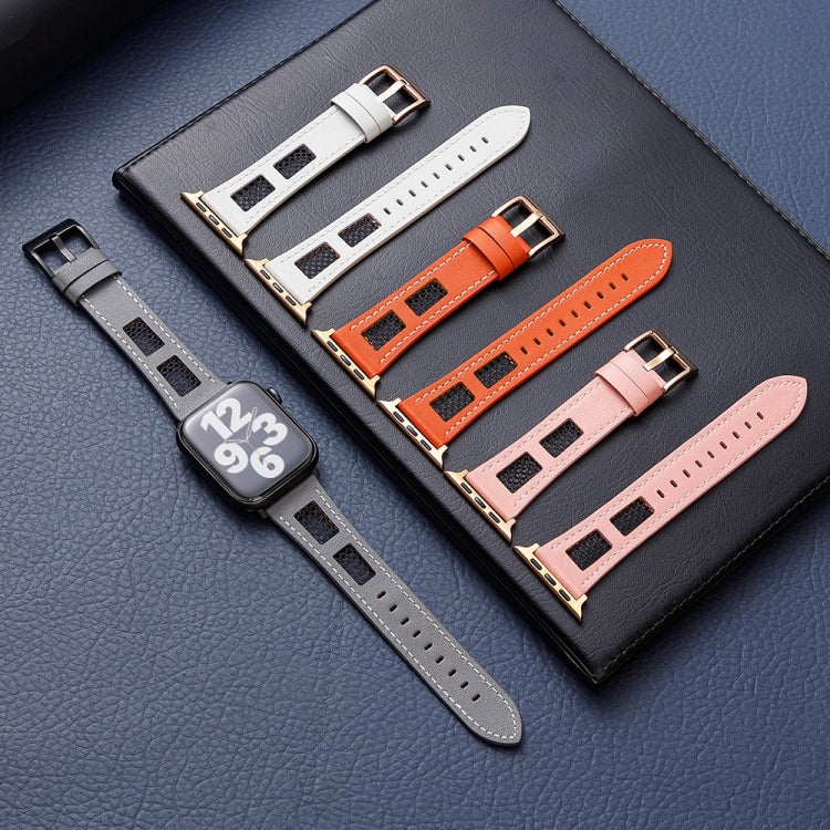 Gray, white, orange and pink leather watch bands with rectangular mesh panels beside a watch