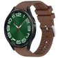 Brown fluororubber watch band fitted to a black smartwatch.