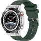 Dark green fluororubber watch band fitted to a silver smartwatch.