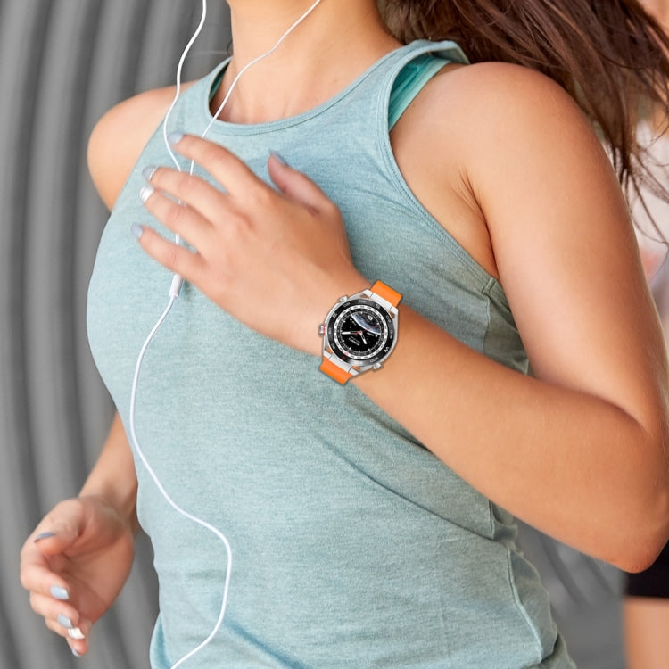 Orange fluororubber watch band worn on the wrist with a smartwatch