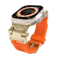 Apple Watch band with gold-tone metal connectors and an orange TPU strap