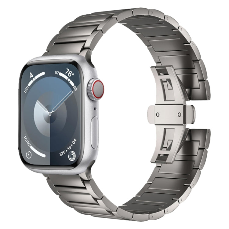 Dark metal watch band with polished links and a butterfly buckle