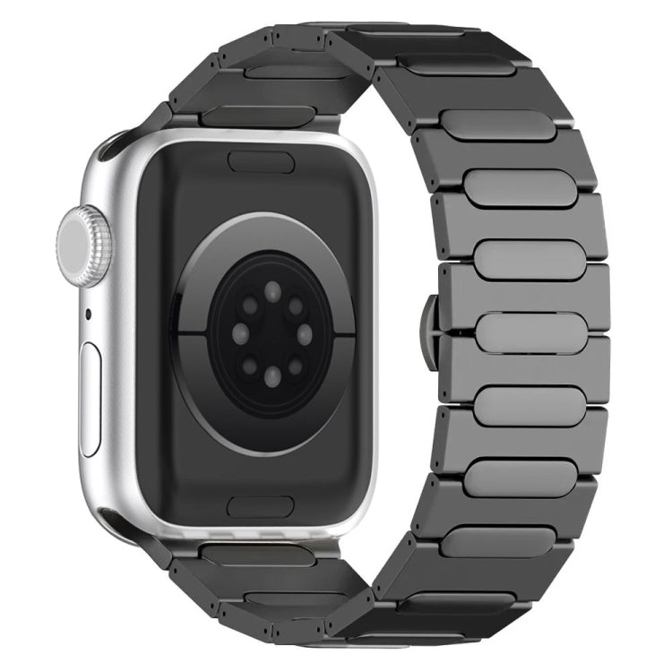 Black titanium alloy Apple Watch band with linked oval plates, shown attached to a silver watch.