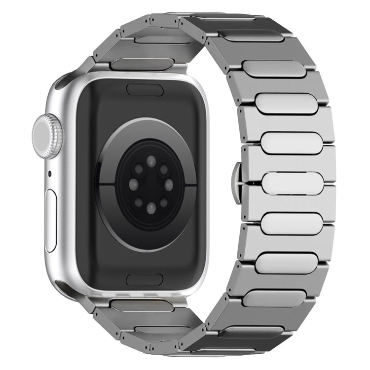 Silver titanium alloy watch band with linked oval buckle and watch shown from the back