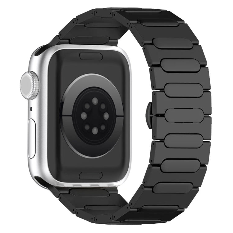 Black titanium alloy Apple Watch band with linked oval plates, shown attached to a silver watch.