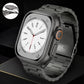 Dark gray titanium link watch band attached to a smartwatch, with clasp detail inset.