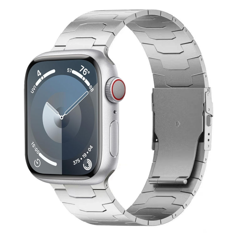 Silver titanium alloy Apple Watch band with wide segmented links and safety buckle, shown on watch