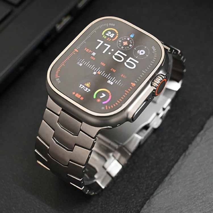 Titanium alloy Apple Watch band with broad linked bracelet, fitted to a watch