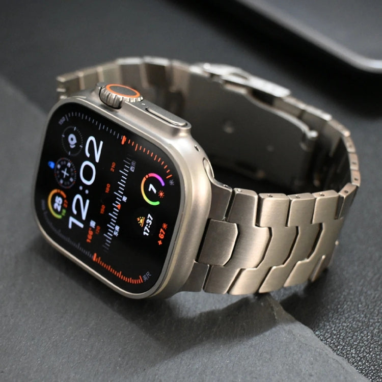 Titanium alloy Apple Watch band with broad links and safety buckle, shown from the side