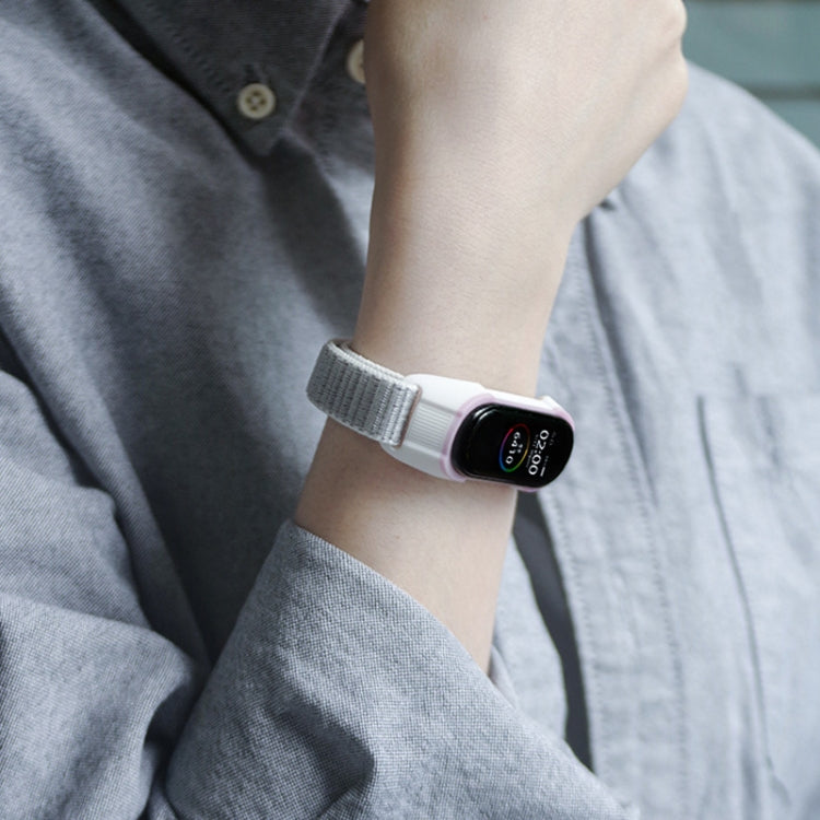 Gray and pink nylon smartwatch strap on wrist, watch face visible