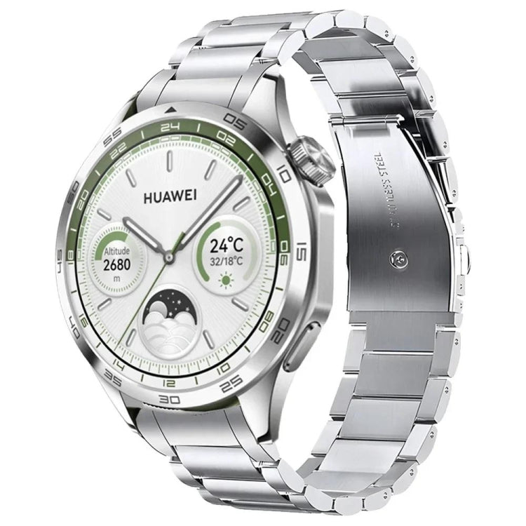 Silver stainless steel watch band with curved links, shown attached to a Huawei watch.