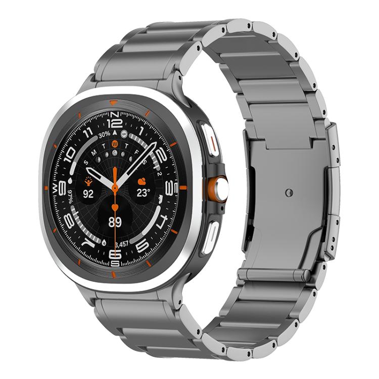 Gray metal watch band with a Galaxy smartwatch and a wide folding clasp.