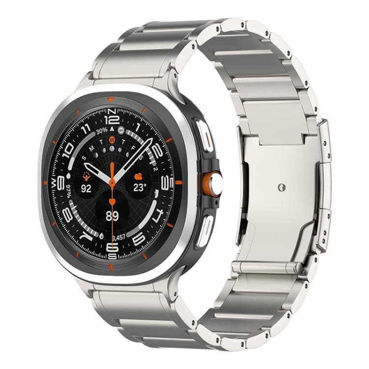 Titanium-tone metal watch band with a Galaxy smartwatch and a wide folding clasp.