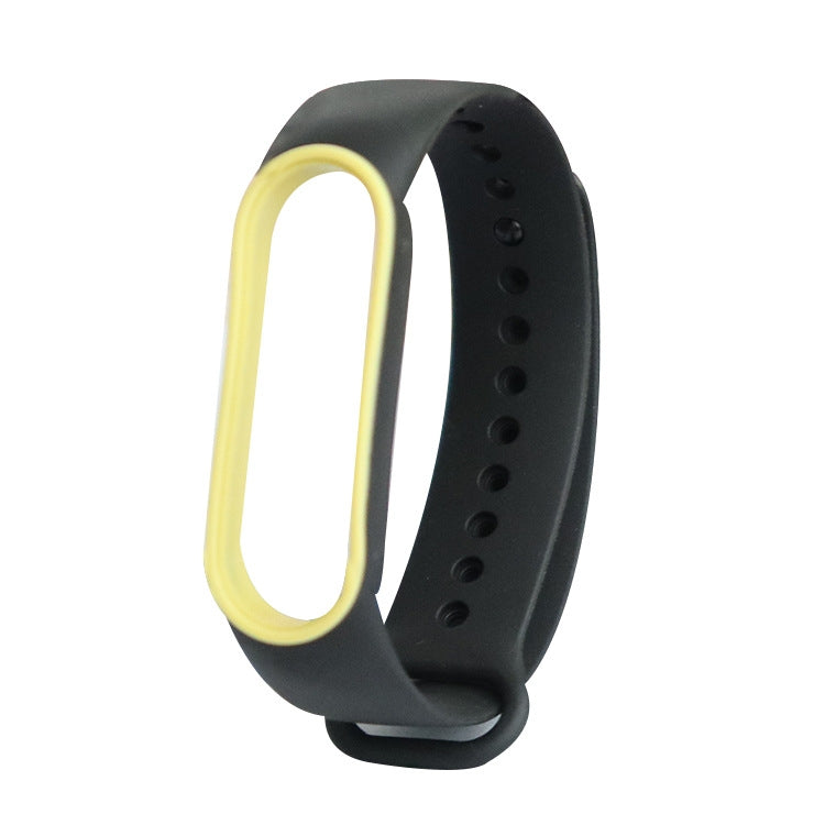 Two-tone TPE smartwatch strap for Mi Band 5, black with yellow inner loop and pin holes.