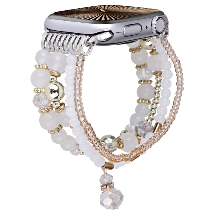 White beaded Apple Watch band with chain strands and a dangling crystal charm