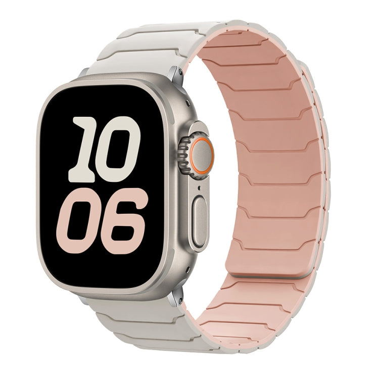 Apple Watch with a two-tone silicone band in starlight and pink sand