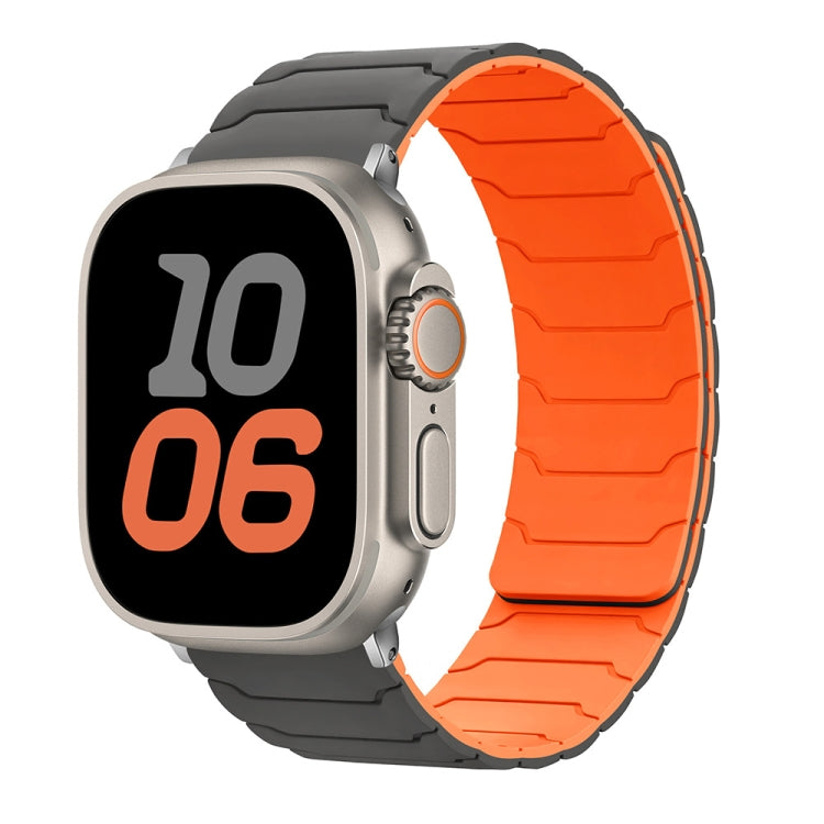 Apple Watch with a black and bright orange silicone band
