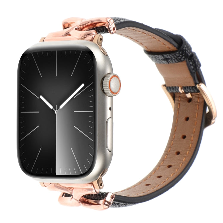 Black leather Apple Watch band with tan lining and rose gold X-shaped connectors