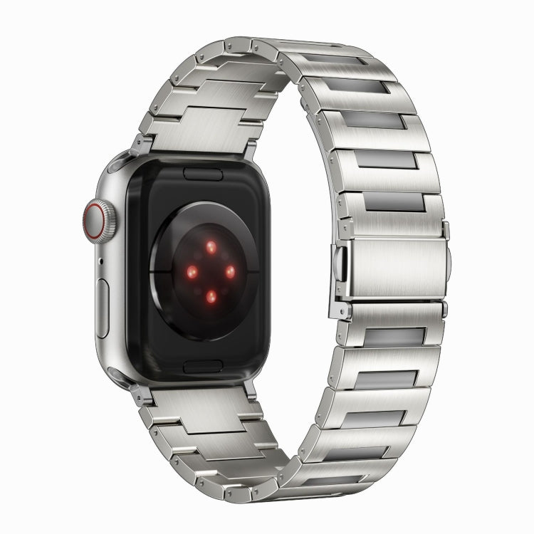 Silver titanium alloy watch band attached to an Apple Watch, shown from the back.