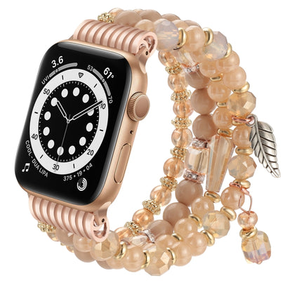 Apple Watch band with peach beads, gold accents, crystal charms, and a rose gold watch case