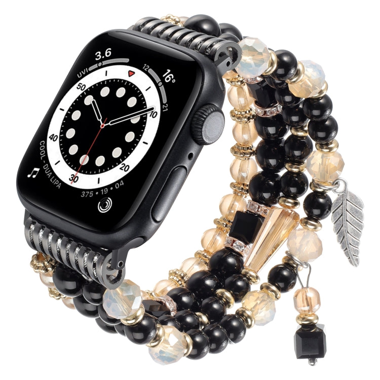 Apple Watch band with black beads, gold accents, crystal charms, and a black watch case