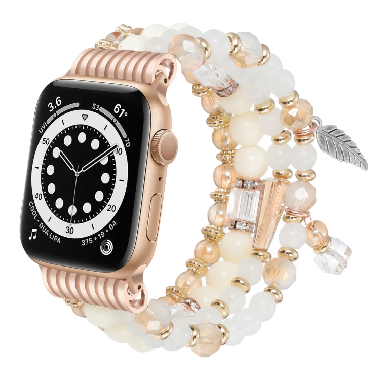 Apple Watch band with cream beads, gold accents, crystal charms, and a rose gold watch case