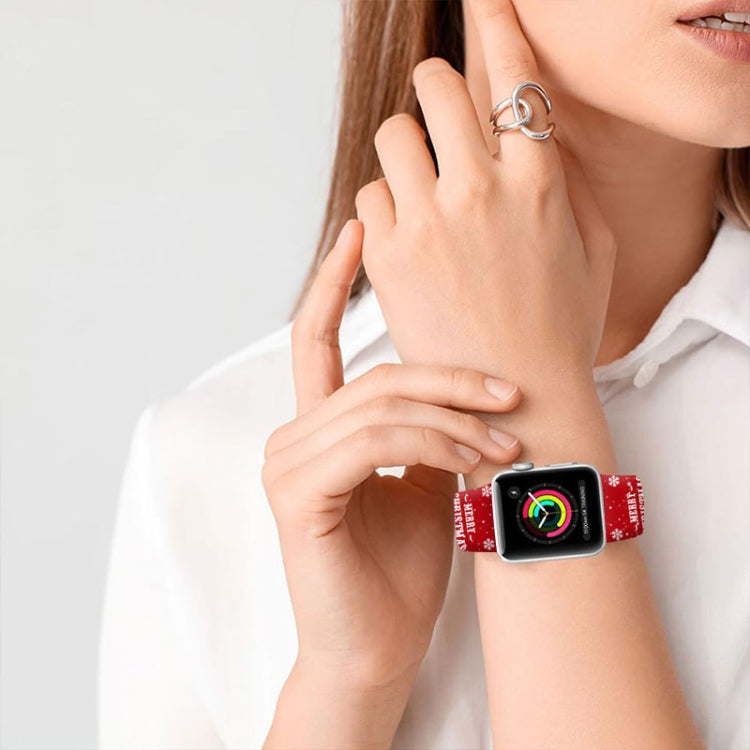 Red Christmas-pattern Apple Watch band worn on wrist