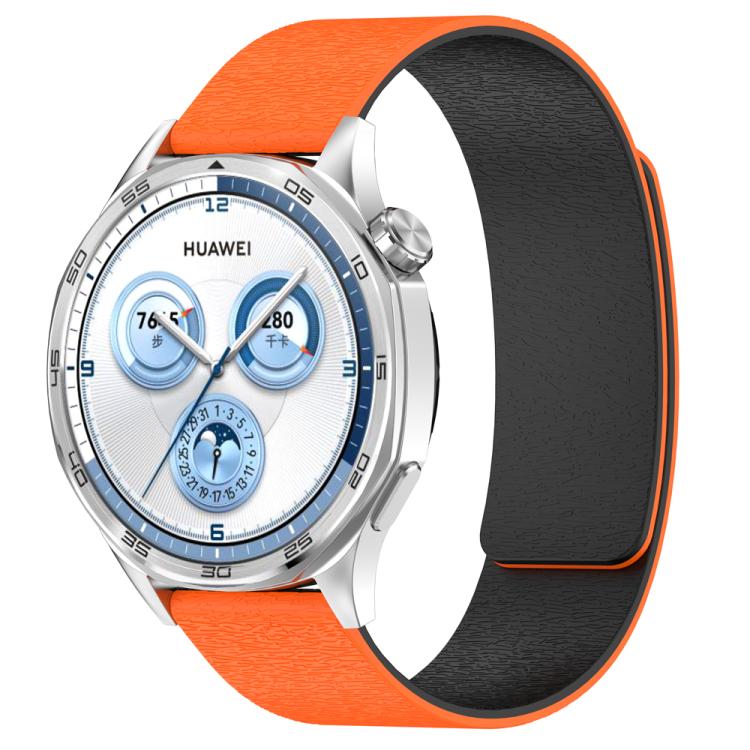 Orange silicone magnetic watch band with black lining, shown attached to a Huawei watch