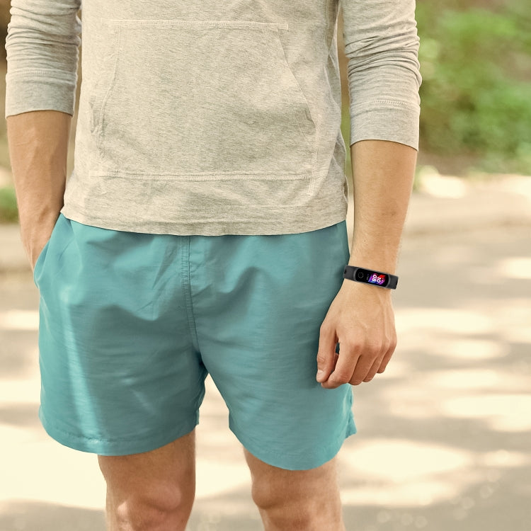 Black metal buckle silicone smartwatch strap worn on wrist