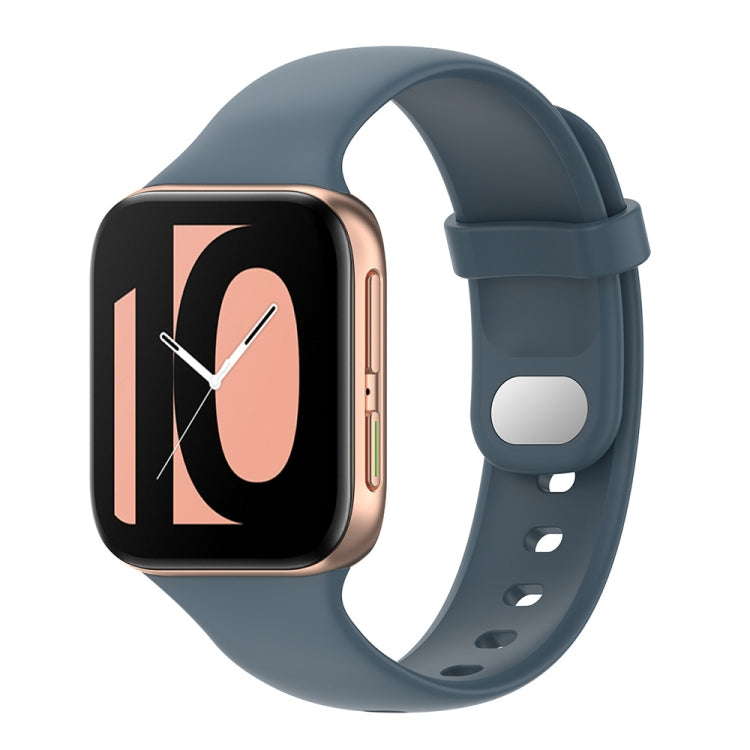 Gray-blue silicone watch strap with adjustable holes and smartwatch face visible