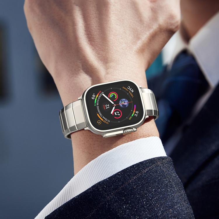 Silver titanium Apple Watch band fitted to a smartwatch on a wrist