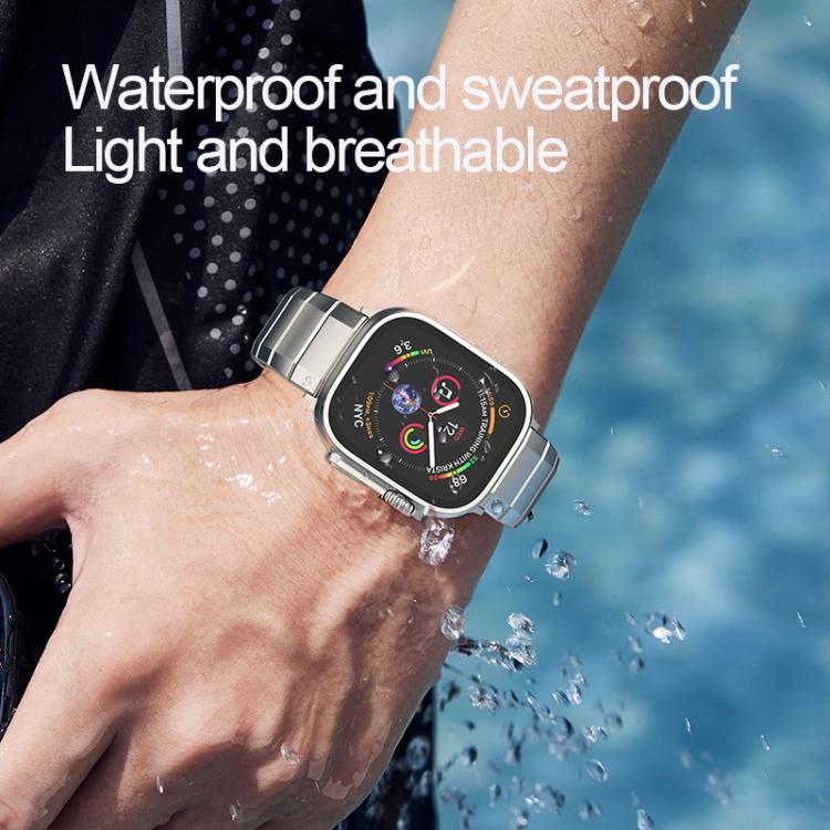 Silver linked titanium Apple Watch band worn on a wrist near splashing water
