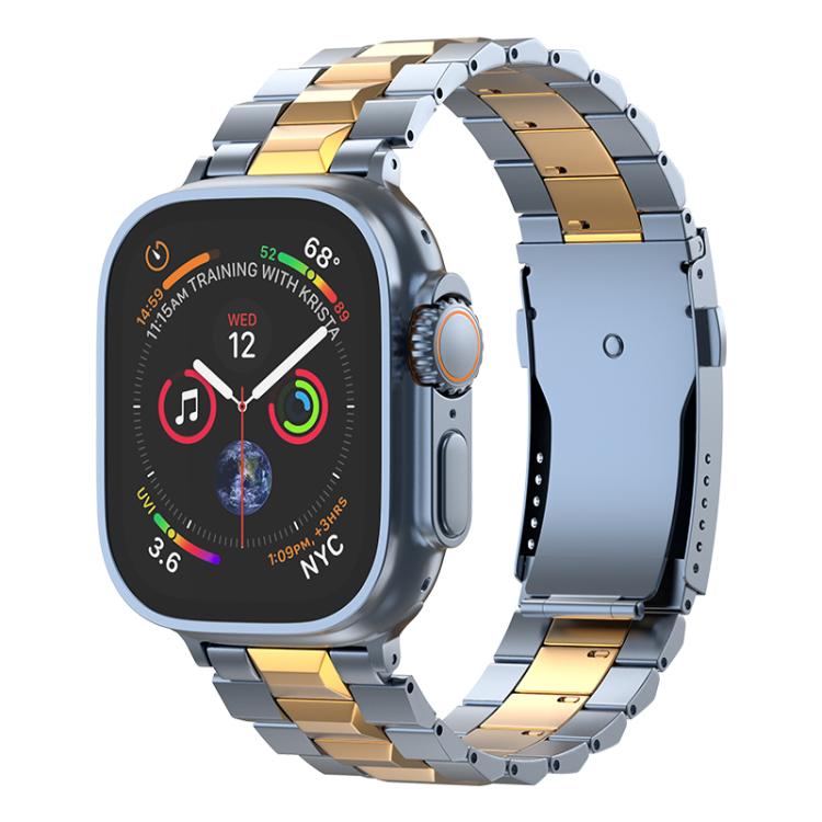Blue-gray and gold titanium link watch band with a folding clasp, shown on an Apple Watch.