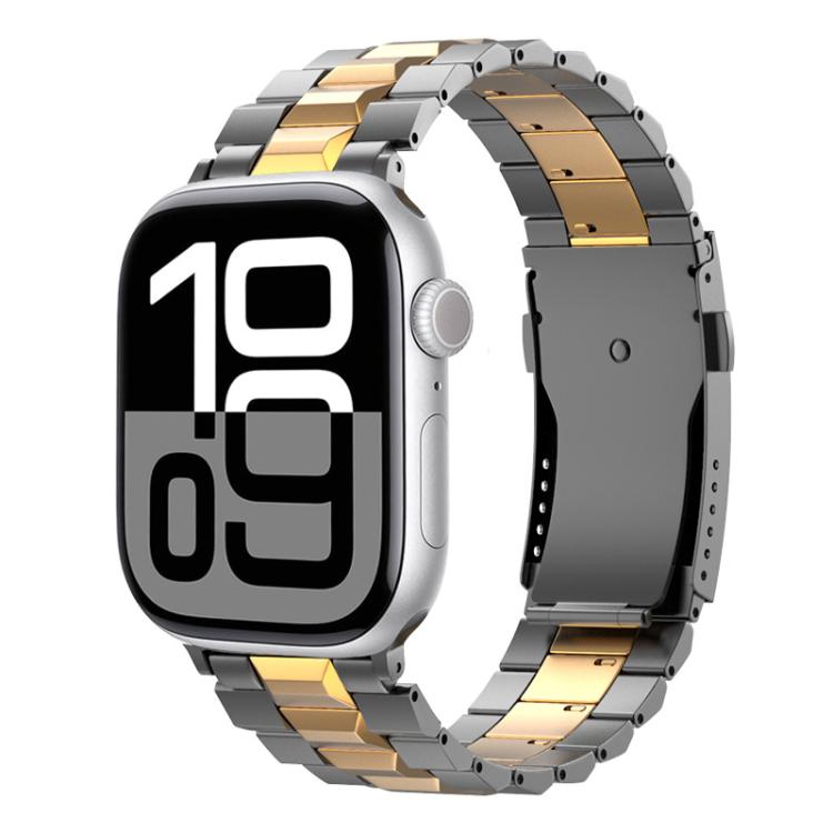 Two-tone gray and gold titanium link band on an Apple Watch with a digital display.