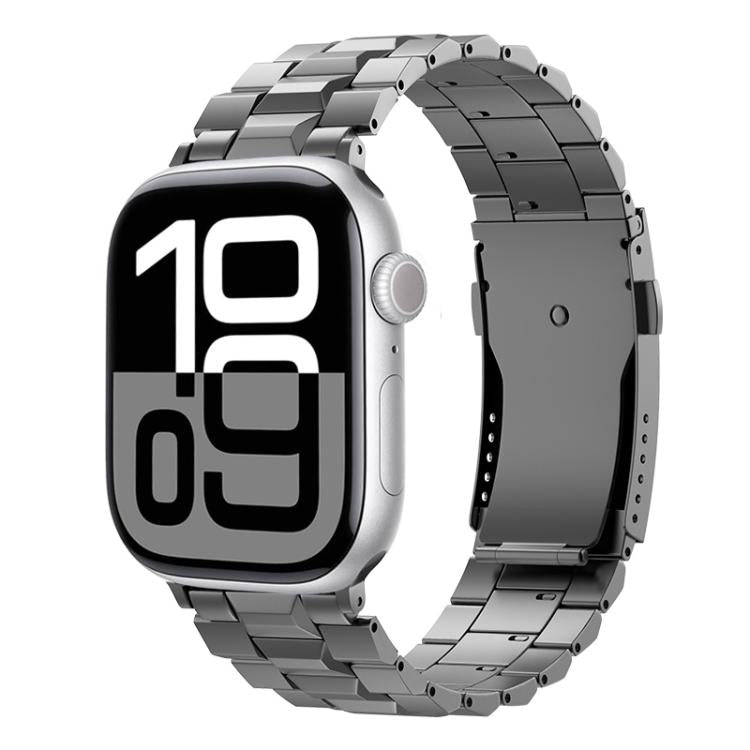 Dark gray titanium link band with folding clasp on an Apple Watch with a digital display.