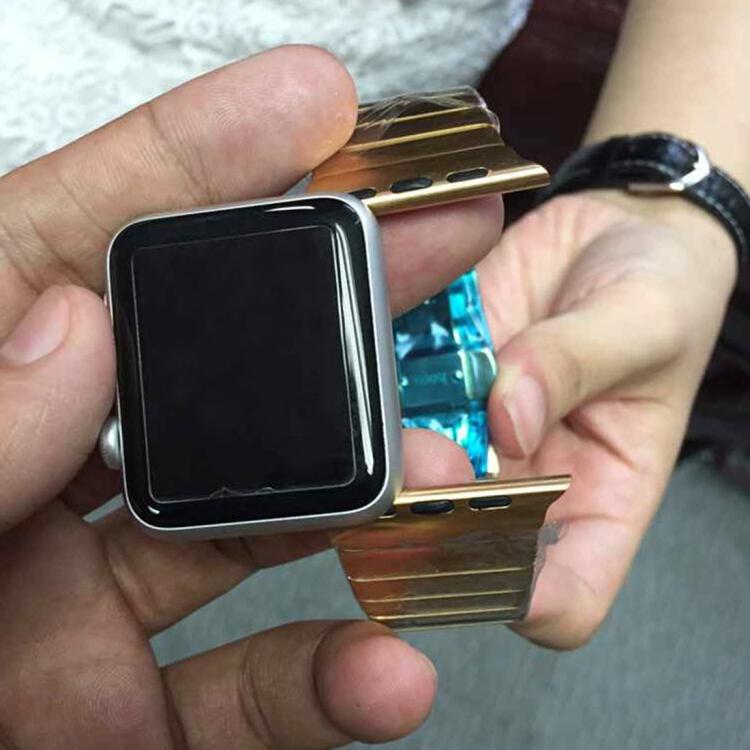 Gold stainless steel watch band attached to a smartwatch