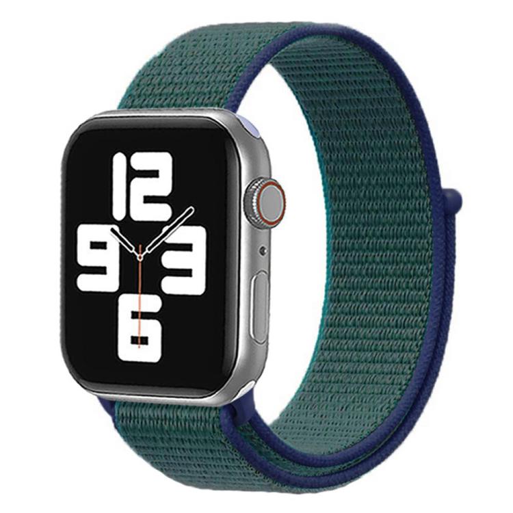 Apple Watch with a dark green woven nylon band and navy hook-and-loop trim