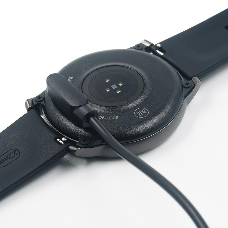 Magnetic charging cable attached to the back of a Haylou Solar LS05 smartwatch