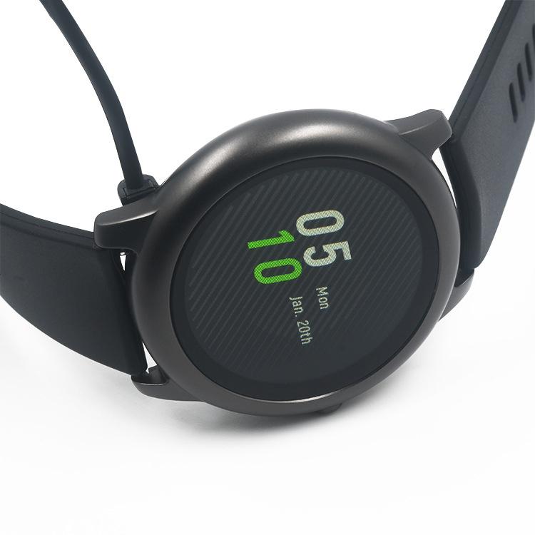 Black Haylou Solar LS05 smartwatch connected to its charging cable