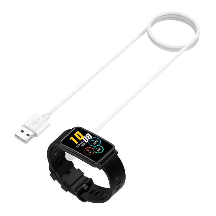 White magnetic USB charging cable beside a black rectangular smartwatch