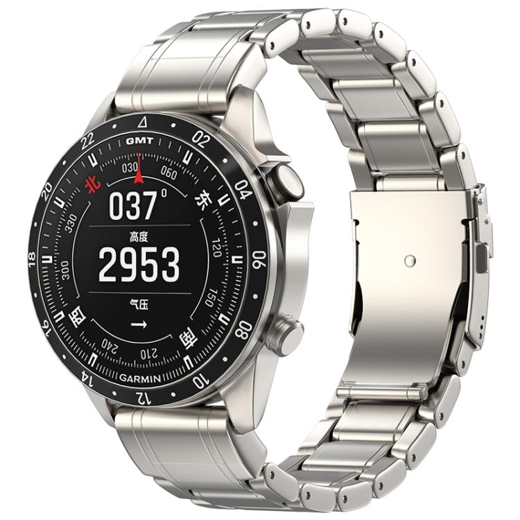 Titanium-color metal watch band with safety clasp, shown on a Garmin watch