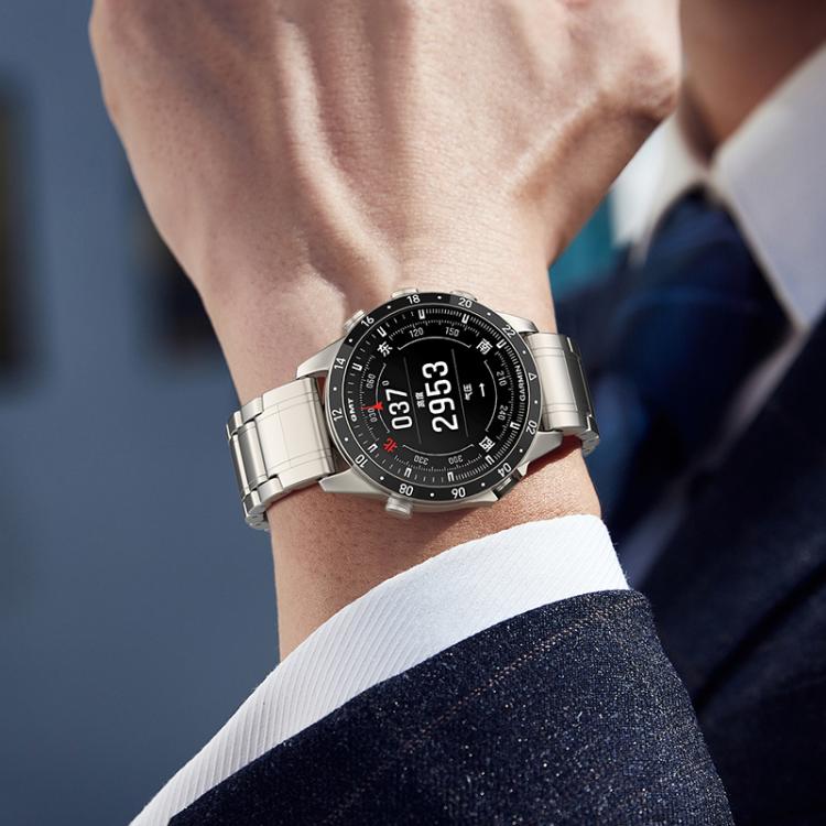 Silver linked titanium watch band worn on the wrist with a round black watch