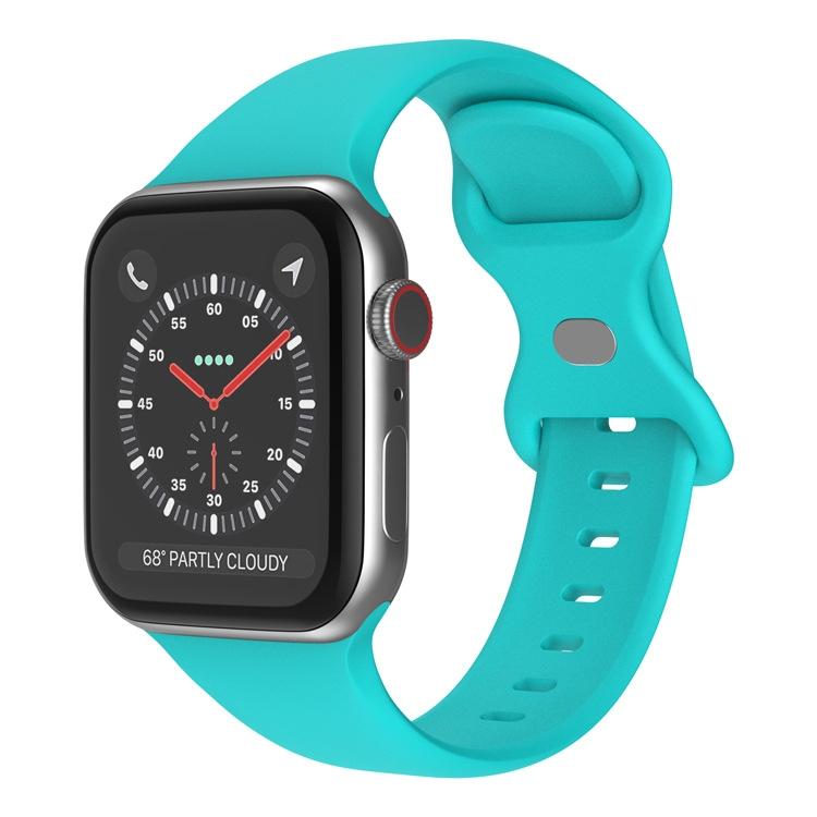 Teal silicone Apple Watch band with butterfly buckle, shown attached to a watch