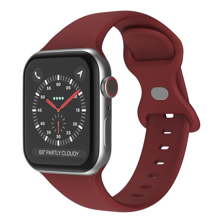 Wine red silicone butterfly buckle Apple Watch band shown attached to a watch